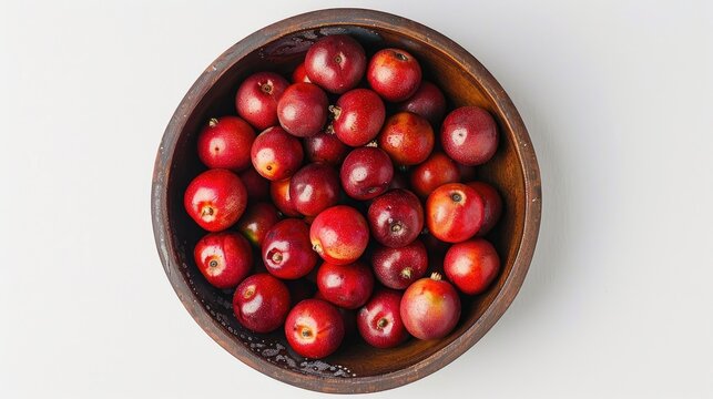 Melinjo fruit in a bowl from a high aerial perspective on a white backdrop