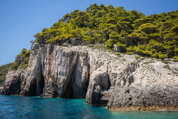 Beautiful Scenery of Rock Formation with Green Tree and Turquoise Water in Zakynthos. Rocky Cliff with Ionian Sea in Keri in Summer Day in Greece.