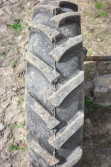 Close up photo of a tractor tire tread, selective focus.