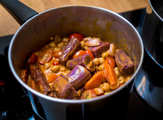 Chef at the kitchen preparing massaman curry with sweet potato and many spices