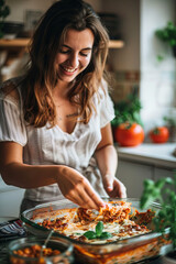 Happy woman portioning lasagna as part of meal prep
