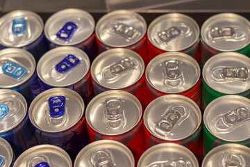 beer or juice cans arranged in rows on the shelf