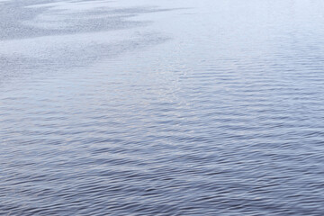 
Sparkling blue water with small waves in it