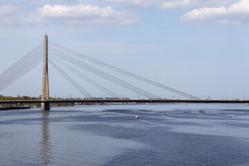 
reinforced concrete bridge with metal wires over the river