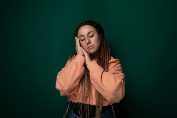Woman With Dreadlocks Holding Head in Hands
