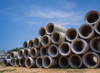 A stack of concrete ring pipes piled and creating a symmetrical arrangement