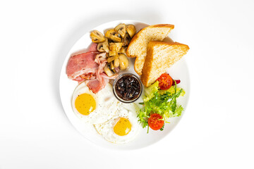 Breafast of fried eggs, bacon, mushrooms, salad, toasted brioche bread