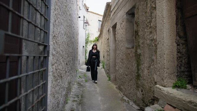 Woman Walks Through Narrow Alleys Of An Ancient Village Of Gerace
