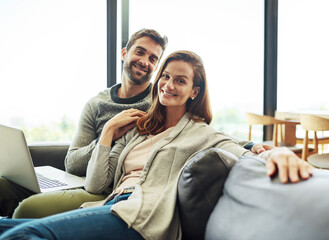 Fototapeta premium Portrait, smile and couple on laptop for relax, support and connection for love together in home. Happy man, woman and computer on sofa for social media, news and streaming on website in living room