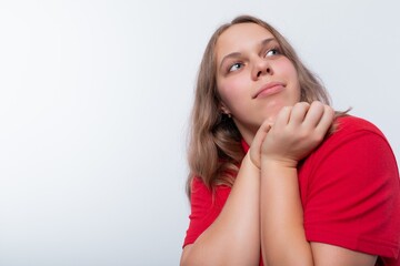 Fototapeta premium Dreamy teenager girl thinking on a white background