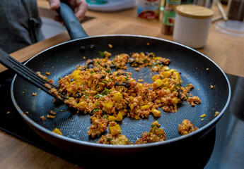 Chef at the kitchen preparing quesadillas with tofu and sweet corn