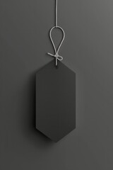 Blank black empty sale tag for hanging isolated on grey background. Vertical orientation