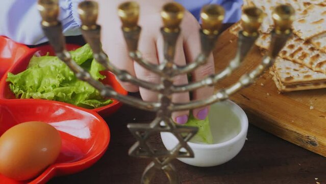 Jewish woman eating maror with matzoh meal Pesach Seder. Medium plan.