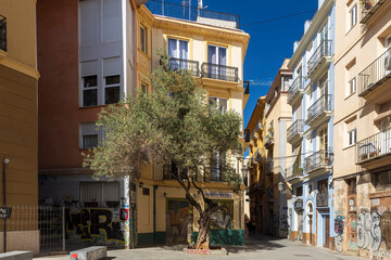 Fototapeta premium VALENCIA, SPAIN - May 2, 2024: Narrow streets with colorful houses in the old town. Street de santa elena valencia