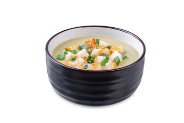 Celery greens soup with cream and scallions in a bowl on a white isolated background