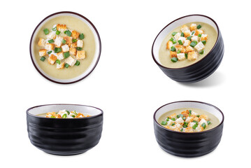Celery greens soup with cream and scallions in a bowl on a white isolated background