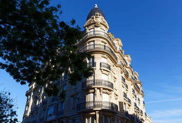 The facade of traditional French house with typical balconies and windows. Paris.