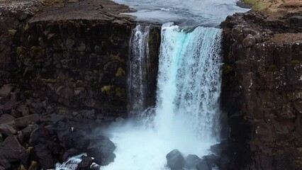 Aerial view of Oxarafoss waterfall in Thingvellir National Park, Iceland. See the Oxara River and the tectonic plates of America and Eurasia. Stunning natural scenery and geological wonder.