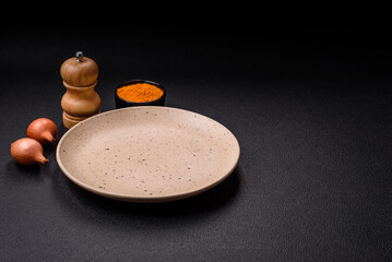 Empty ceramic round plate on dark textured concrete background