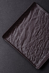 Empty ceramic round plate on dark textured concrete background