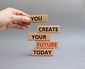 Future and development symbol. Wooden blocks with words You Create your Future today. Businessman hand. Beautiful grey background. Business and Future and development concept. Copy space.