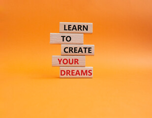 Dreams symbol. Concept words Learn to create your Dreams on wooden blocks. Beautiful orange background. Business and Learn to create your Dreams concept. Copy space.