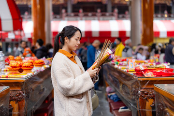 Asian woman pray in Chinese temple
