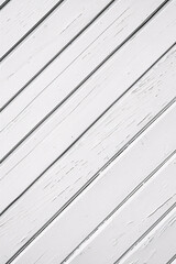 White wooden planks arranged diagonally creating a clean textured pattern with visible grain