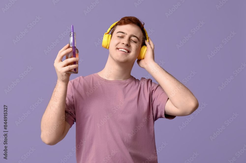 Sticker young man in headphones with bottle of soda on lilac background