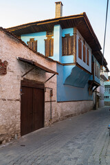 Traditional Kula houses with wooden structure in Turkish and Ottoman architectural style, Manisa, Türkiye. Historical buildings and houses on the streets of Manisa.