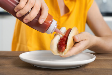 Person Adding Ketchup to Hot Dog, lunch, breakfast