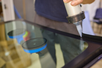 Use professional adhesive when repairing windshield glass for autos to ensure a secure installation