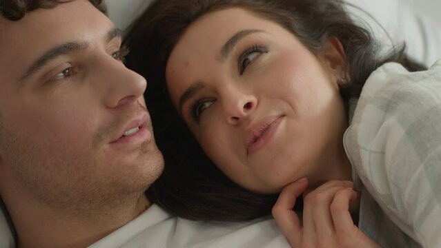 Close up happy couple talk bedroom bed man woman female male smile home cuddle relationship romance intimacy moment feeling sweetheart honeymoon girlfriend boyfriend sensuality love togetherness bond