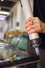 Use professional adhesive when repairing windshield glass for autos to ensure a secure installation