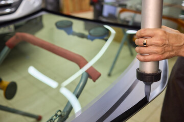 Use professional adhesive when repairing windshield glass for autos to ensure a secure installation