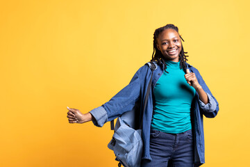 Smiling african american teenager having fun, dancing on rhythm, enjoying leisure time. Jolly BIPOC...
