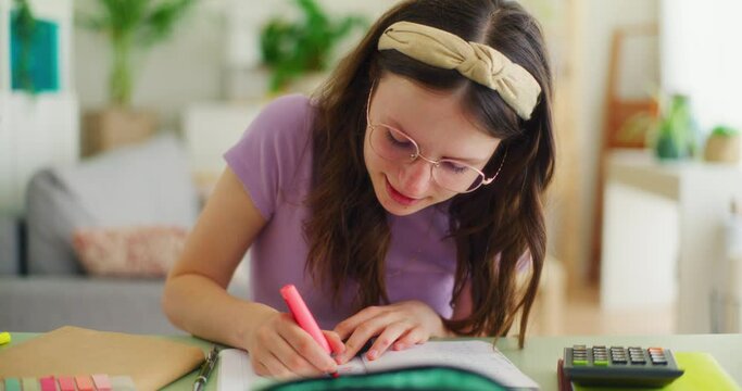 Satisfied and Happy Young Student Doing Homework at the Desk