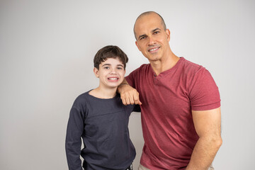 Fototapeta premium Father and son hugging and smiling looking at the camera. Photos in studio_1.