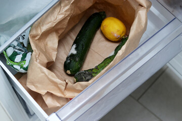 Close up of rotten vegetables in a paper eco bag 