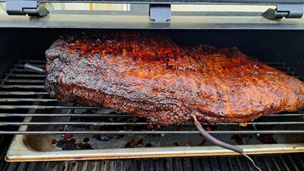 Beef brisket smoked on a charcoal or pellet smoker fat cap up