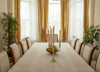 empty long vintage dining table with chairs in interior
