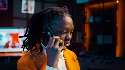 Student calling her professor to discuss about class materials, organizing study schedules and timelines based on online lessons. African american girl talking on smartphone call. Camera B.