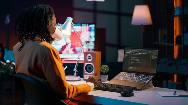 College student learning about outsourcing with html script, enjoying e learning and online courses. Woman using programming language, improving her coding skills with analytics. Camera A.