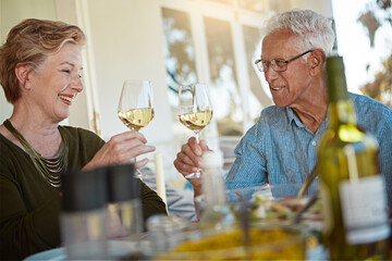 Love, celebration and senior couple with wine toast on patio for anniversary, event or birthday party brunch. Food, happy and old people at an outdoor restaurant with retirement, cheers or bonding