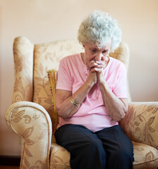 Senior woman, praise and praying in home with pain for hail mary, God and Jesus Christ or heaven. Elderly lady, religion and worship for faith, forgiveness or Holy spirit as Christian saint in house