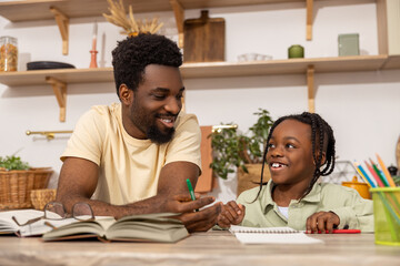 African American man with his daughter studying together