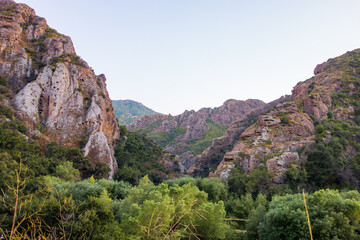 Views of the rough and rocky terrain, with the lush foliage, along with the creek, at Malibu Creek State Park