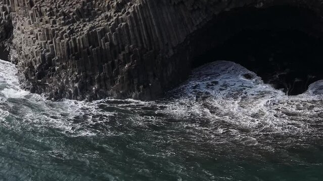 aerial view famous basalt rocks at the Black Beach in Vik, Iceland. Volcanic geological formation. Travel destination, geology, beauty in nature and tourism concept.