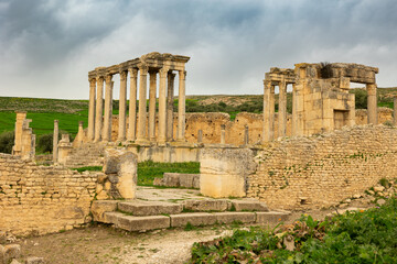 Fototapeta premium View of historical Temple of Juno Caelestis with columns and ruined stone walls in Dougga, Tunisia