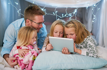 Happy, family and tablet for streaming tv, watching movies or dad telling story before bedtime. Sisters or friends and touchscreen for entertainment with film or social media in blanket fort at home